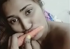 Cute Sexy Indian girl is playing at hand carrot