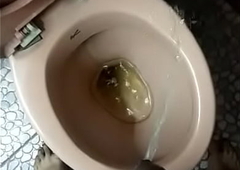 Indian boy pissing in toilet